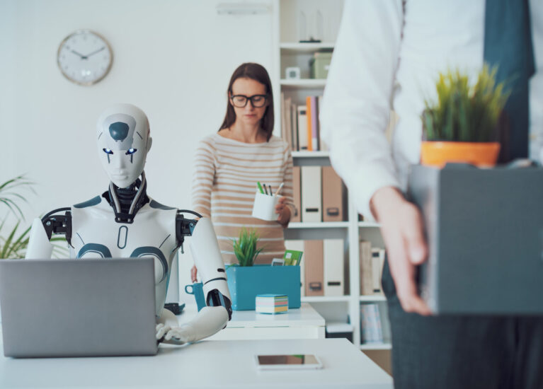 Dismissed business people packing their belongings and leaving the office, a robot is sitting at the desk and working: the impact of AI on jobs