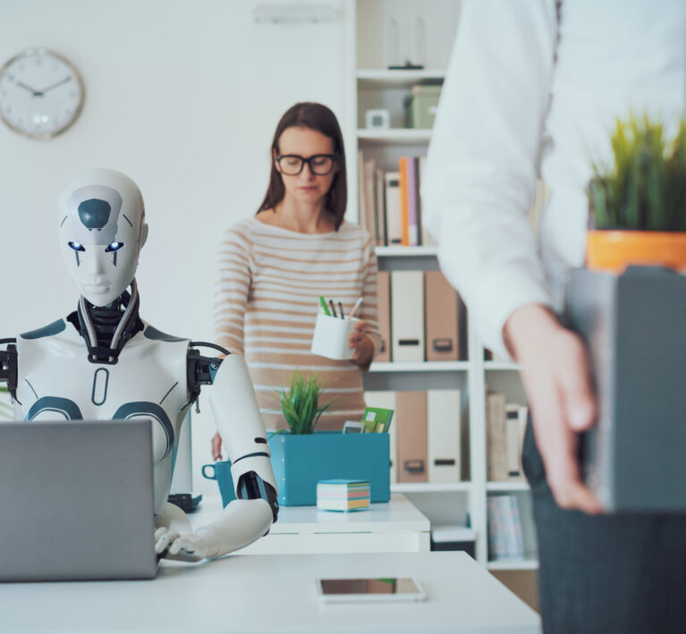 Dismissed business people packing their belongings and leaving the office, a robot is sitting at the desk and working: the impact of AI on jobs